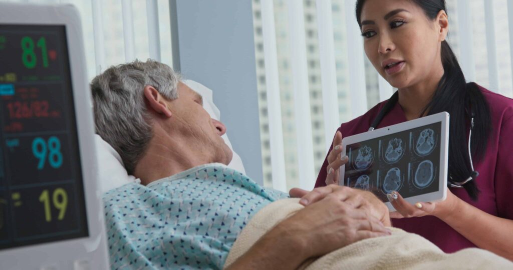 Doctor explaining brain scan results to an injured patient in a hospital room following a serious accident